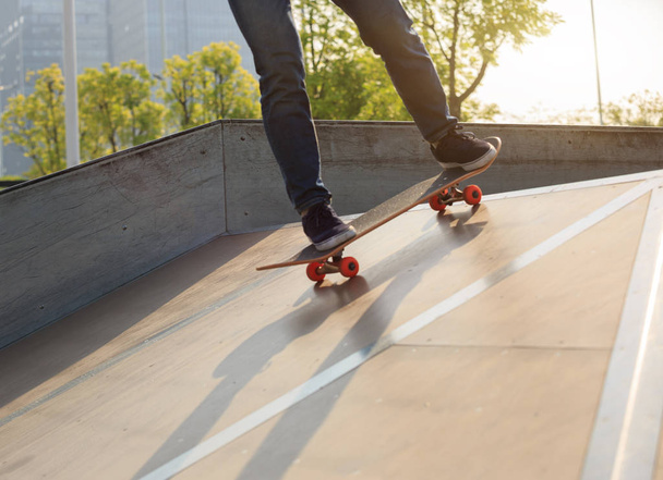 skateboarder practicing on ramp   - Фото, изображение