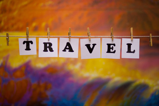 Travel text on papers with clothespins with garland bokeh on background - Фото, изображение