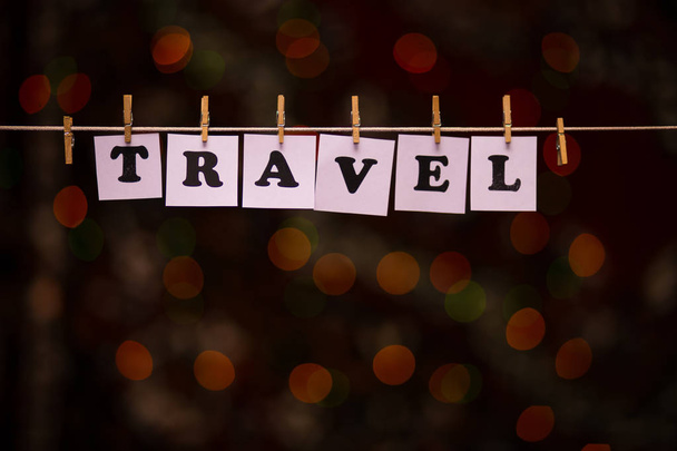 Cestovní text na papírech s clothespins s věnec bokeh na pozadí - Fotografie, Obrázek