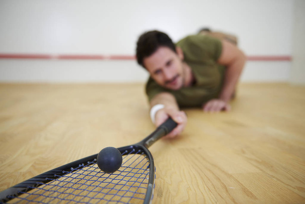 Male player falling on floor while squash game  - Photo, Image