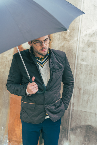 young man with umbrella - Фото, изображение