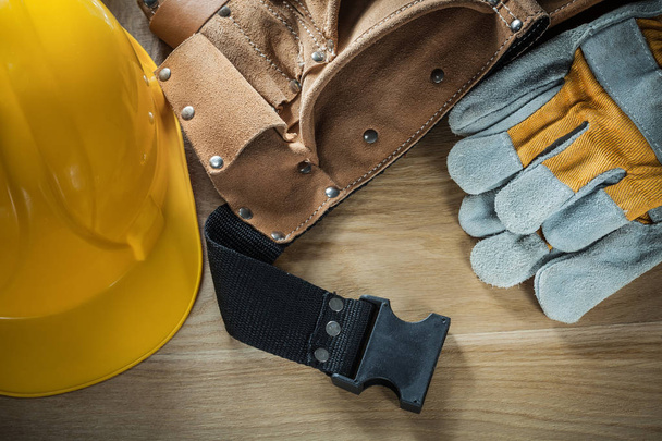 Leather construction belt protective gloves building helmet on w - Foto, Imagem