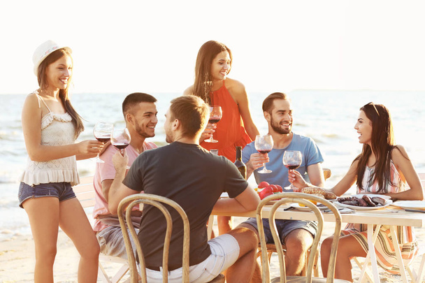 Young people having barbecue party on beach - Photo, image