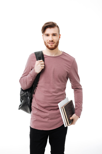 Beau garçon étudiant portant des livres et un sac à dos isolé
 - Photo, image