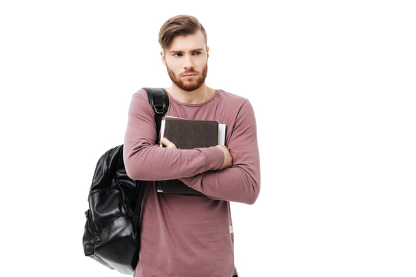 Boos student man met boeken dragen een rugzak geïsoleerd - Foto, afbeelding