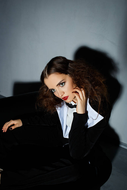 Brunette model posing on couch in the studio - Fotografie, Obrázek