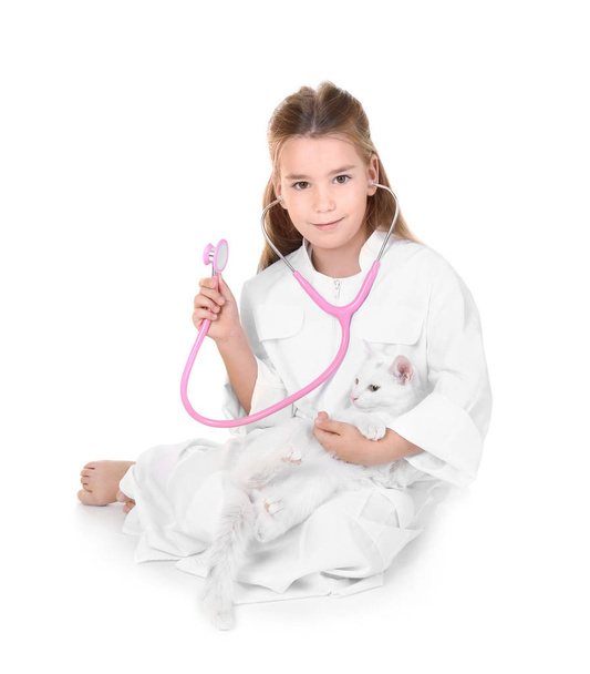Little girl in doctor coat holding cute cat, isolated on white - Zdjęcie, obraz
