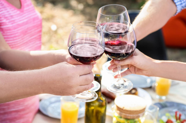 Happy family with glasses of wine having barbecue party outdoors - Photo, Image