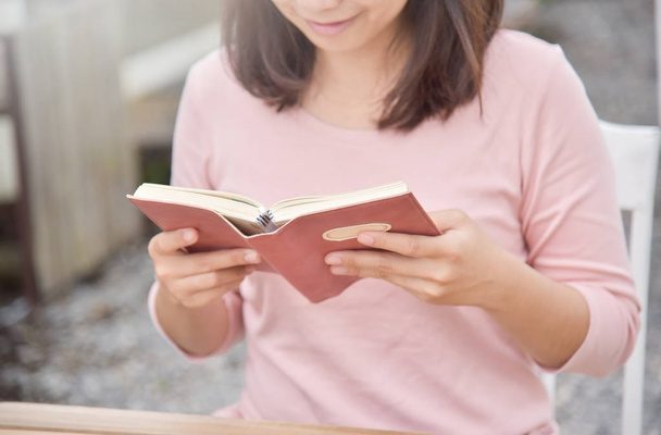 Happy Beautiful Asian Woman reading a book. - Photo, image