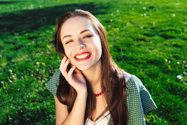 Smiling woman touch face,clear skin,health smile,grass background - Φωτογραφία, εικόνα