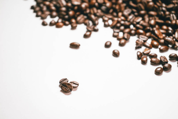 on a white background lie the grains of fragrant Brazilian coffee, arabica - 写真・画像