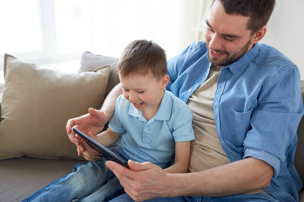 father and son with tablet pc playing at home - Foto, Imagem