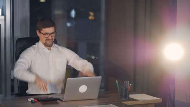 A businessman performs a happy dance at work. - Felvétel, videó