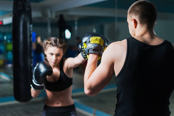 Young fighter boxer fit girl wearing boxing gloves in training - Fotografie, Obrázek
