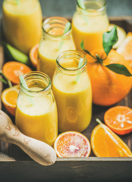 Healthy yellow smoothie in bottles - Foto, afbeelding