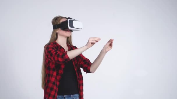 The Young Girl in the Virtual Reality Helmet is Actively Playing the Game - Filmati, video