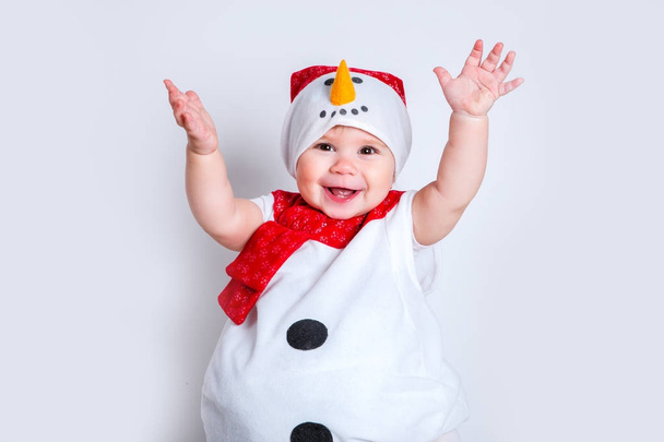 Amazed attractive baby girl in Christmas costume having fun . Close-up portrait little girl in snowman costume - Foto, Imagem