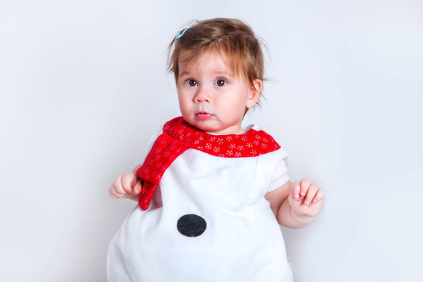 Amazed attractive baby girl in Christmas costume having fun . Close-up portrait little girl in snowman costume - Photo, Image