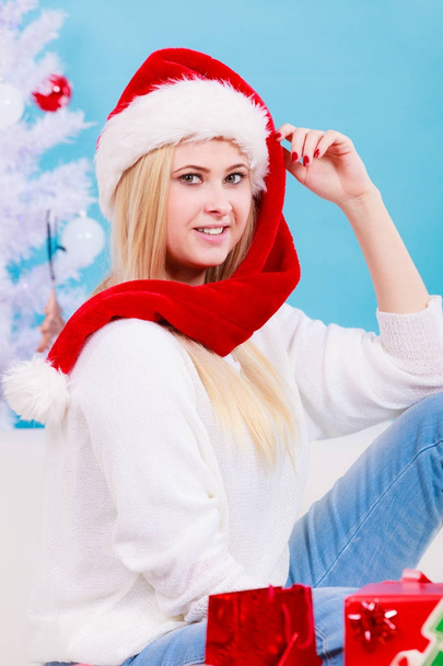 Woman in Santa hat thinking about Christmas - Фото, изображение