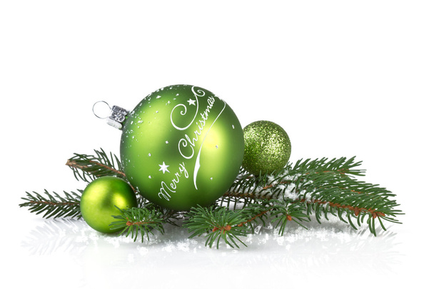 zelený vánoční koule s pobočkou jedle izolované na bílém - 写真・画像