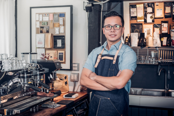 Male Barista cafe owner cross arms in store counter bar inside c - 写真・画像