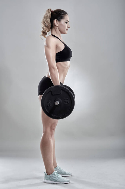Woman doing barbell rows - Photo, image