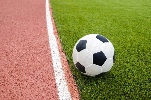 El fútbol está en el campo de fútbol de césped artificial en el estadio
. - Foto, Imagen
