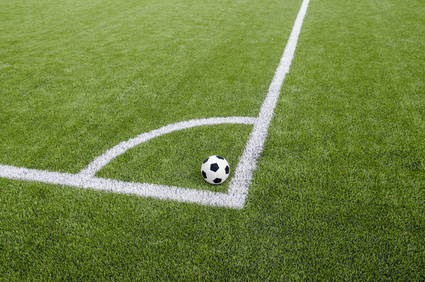 The soccer football in the corner on the artificial green grass field - Foto, imagen