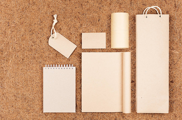 Template of blank kraft recycled paper packaging and stationery on brown coconut fiber background. - Foto, Imagem