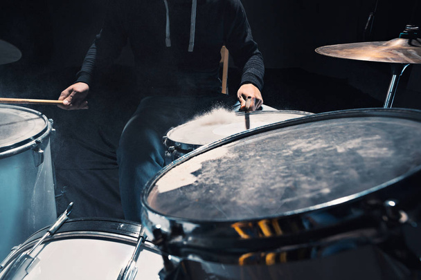 Drummer rehearsing on drums before rock concert. Man recording music on drum set in studio - Valokuva, kuva