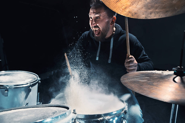 Drummer rehearsing on drums before rock concert. Man recording music on drum set in studio - Foto, Bild