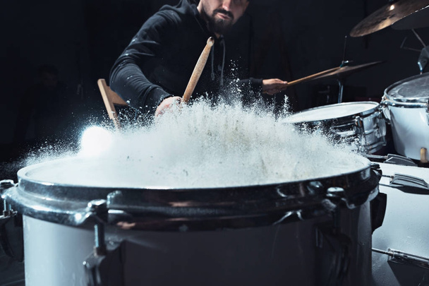 Drummer rehearsing on drums before rock concert. Man recording music on drum set in studio - Fotó, kép