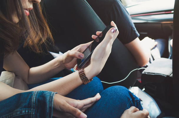 Women using phone in the car - Фото, изображение