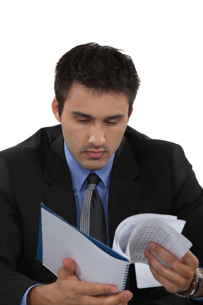 A businessman reading notes. - Zdjęcie, obraz