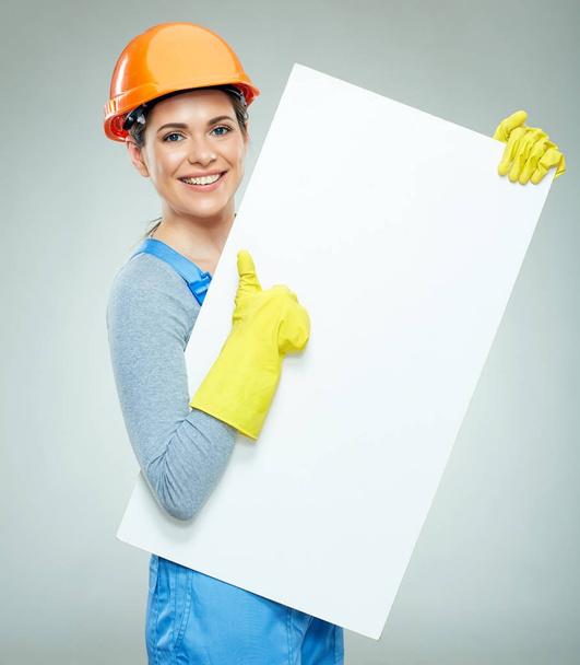 woman builder holding white sign banner and showing thumb up  - Fotó, kép