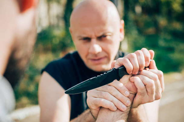 Kapap instructor demonstrates martial arts self defense knife at - Zdjęcie, obraz