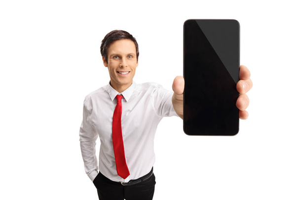 Young businessman showing a phone - Zdjęcie, obraz