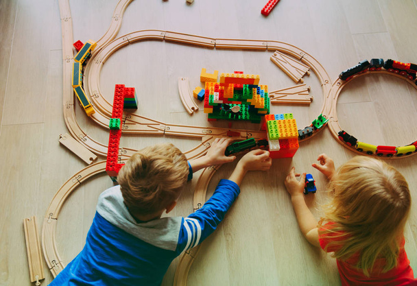 kids playing with toy railroad and trains - Photo, Image