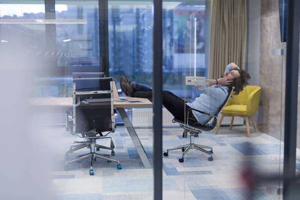 young businessman relaxing at the desk - Fotó, kép