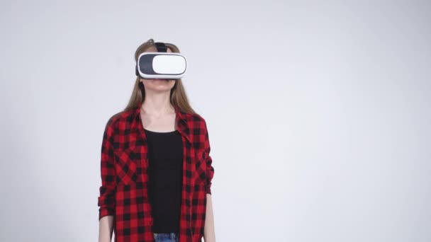 Young Girl in the Virtual Reality Helmet Calmly Exploring the Virtual World - Filmati, video