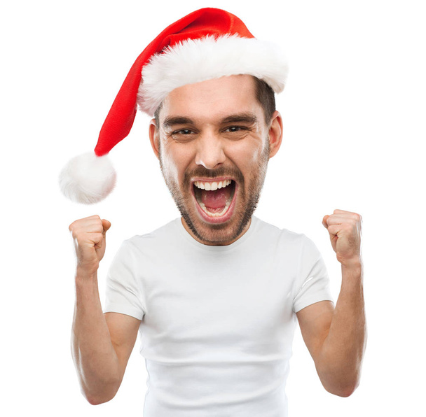 screaming man in santa hat celebrating victory - Фото, изображение