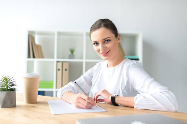 happy businesswoman sitting at table - Photo, Image