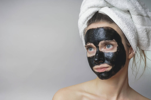 Black mask on woman face,smiling,skincare,cleansing pore,against acne - Fotó, kép