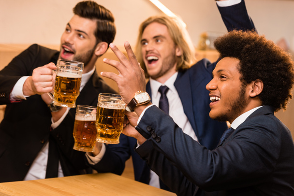 businessmen with beer watching soccer in bar - Foto, Imagem