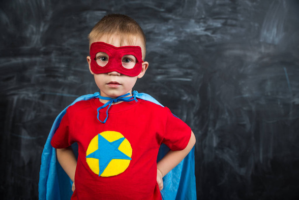 boy superhero in a blue Cape red mask and a red t-shirt with a star - Foto, immagini