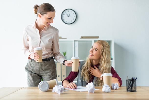 Woman bringing coffee to colleague  - Photo, Image