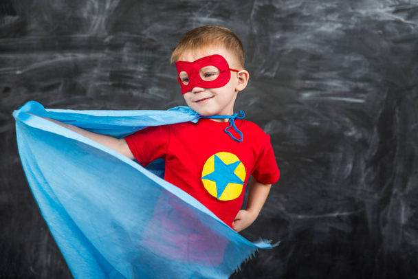 boy superhero in a blue Cape red mask and a red t-shirt with a star - Foto, afbeelding