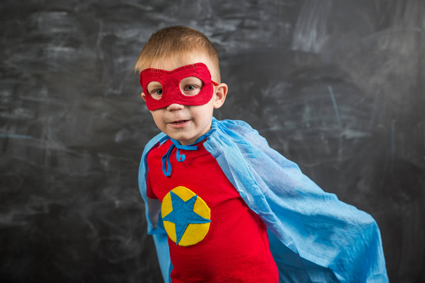 boy superhero in a blue Cape red mask and a red t-shirt with a star - Фото, зображення