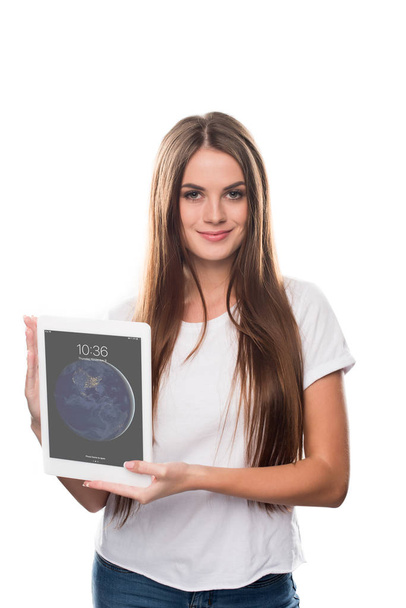 girl holding switched on tablet in hands  - Photo, image