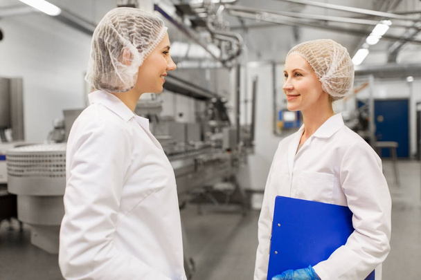 happy women technologists at ice cream factory - Valokuva, kuva